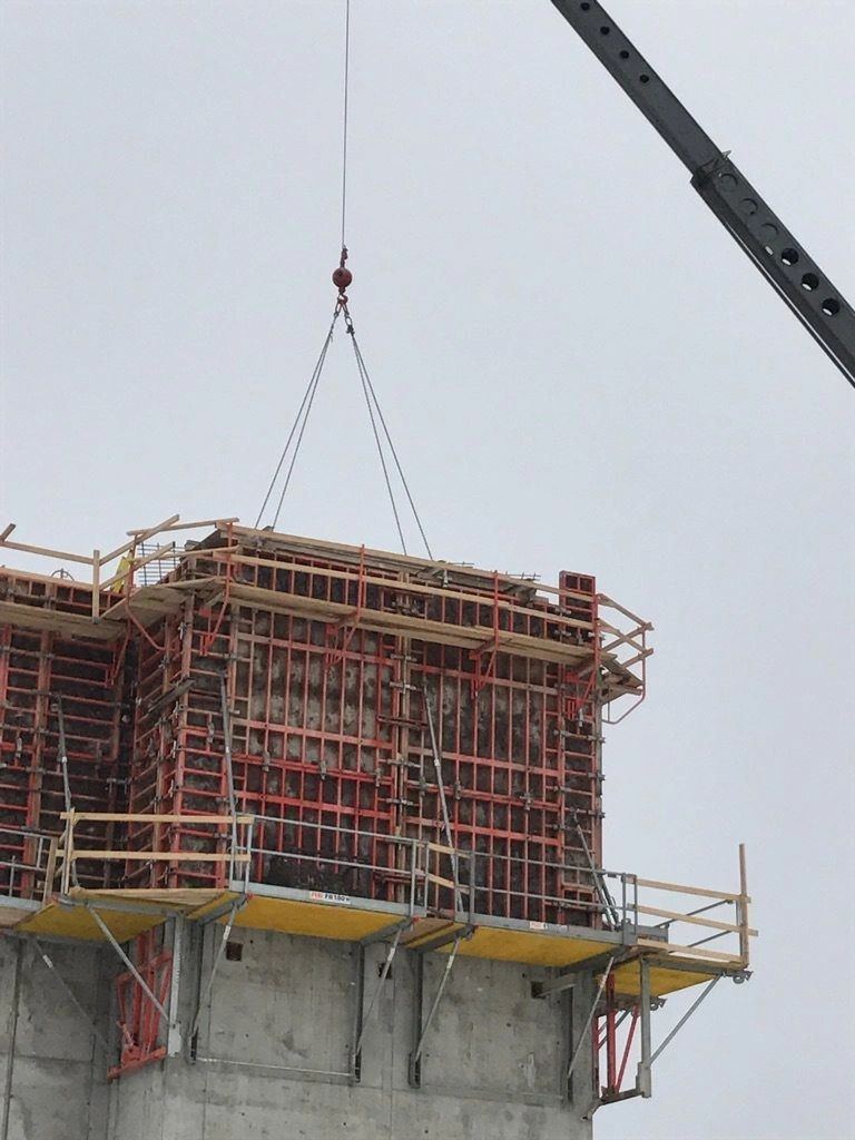 A column form lifted into place on a concrete core
